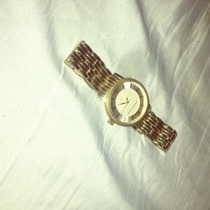 Gold Geoffrey Beene watch.